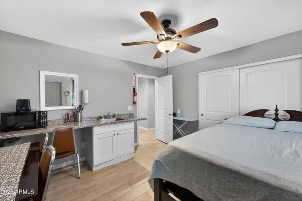 a bedroom with a bed and a chandelier