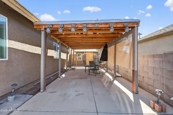 a view of a patio with table and chairs and wooden floor