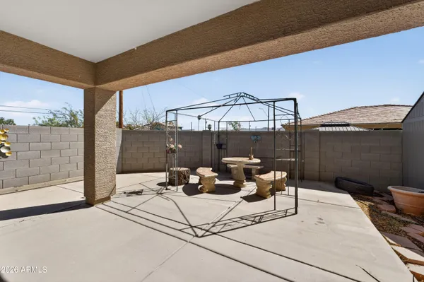 a view of a patio with table and chairs and potted plants