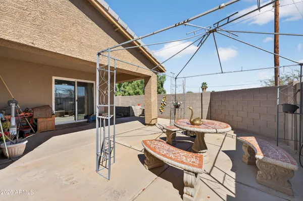 a view of a patio with table and chairs with wooden floor and fence