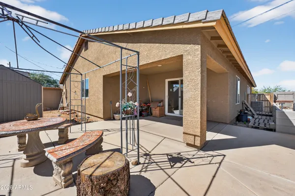 a view of a chairs and table in the patio and a fire pit