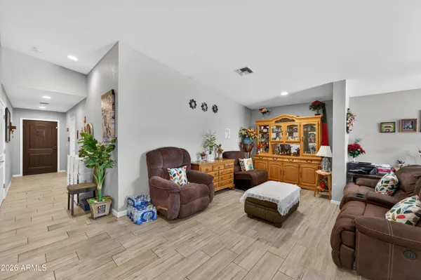 a living room with furniture and a chandelier