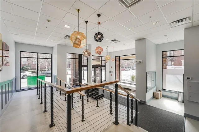 a room with lots of wooden furniture and large windows