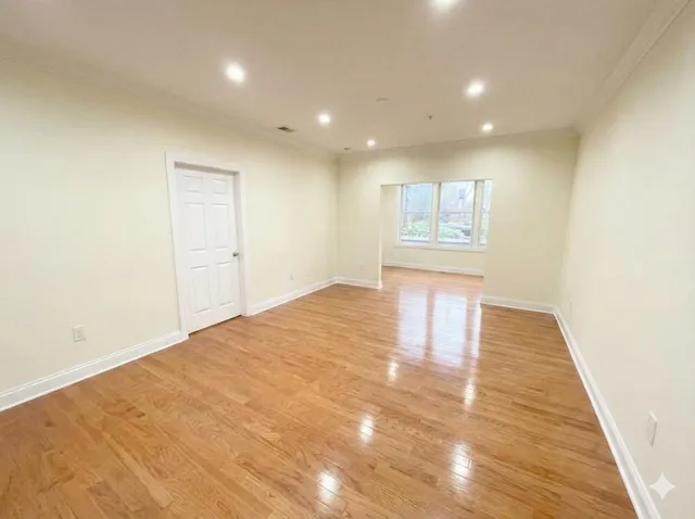 a view of hallway with wooden floor