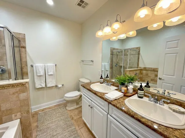 a bathroom with a double vanity sink and a mirror