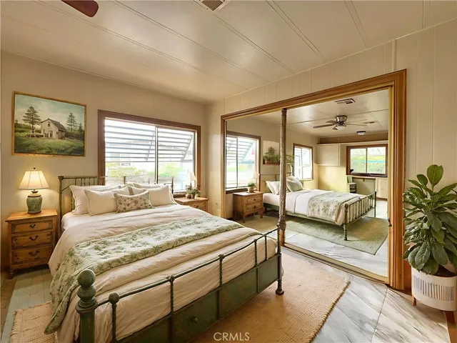 a bedroom with a large bed and a large window