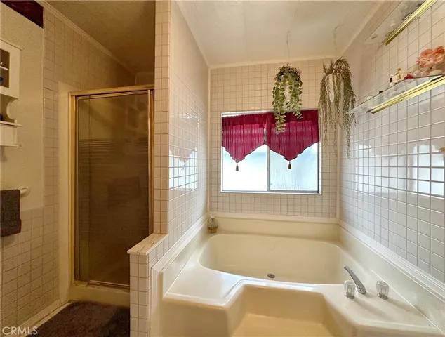 a bathroom with a tub and shower