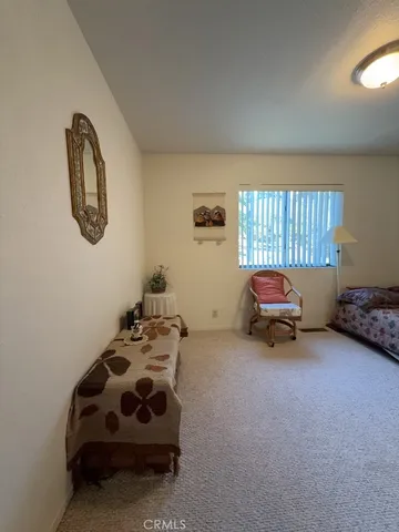 a bedroom with bed and a chair