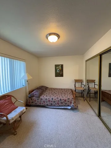 a bedroom with furniture and a chair