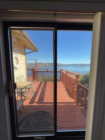 a view of a balcony with wooden floor and outdoor space