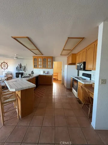 a kitchen with stainless steel appliances a stove a sink and a refrigerator