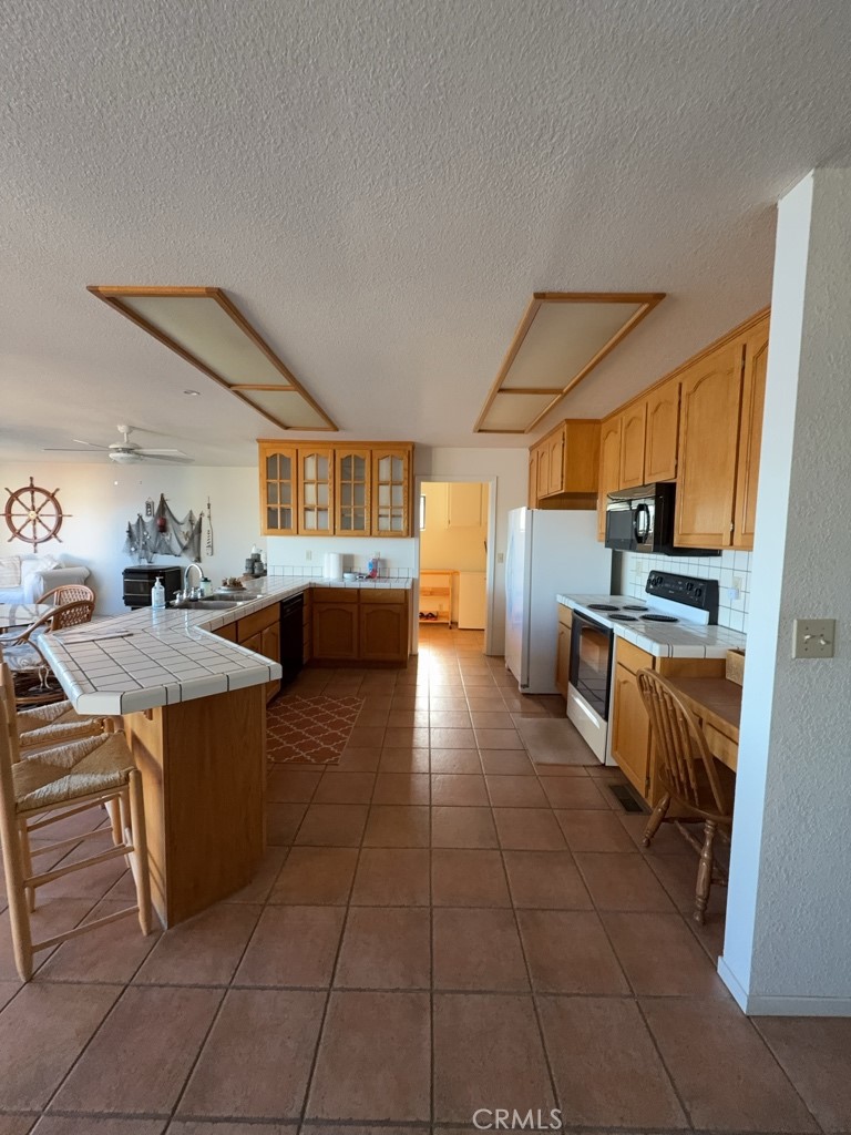 4816 Marina Drive Kelseyville, CA 95451 - Photo 4 of 28 a kitchen with stainless steel appliances a stove a sink and a refrigerator