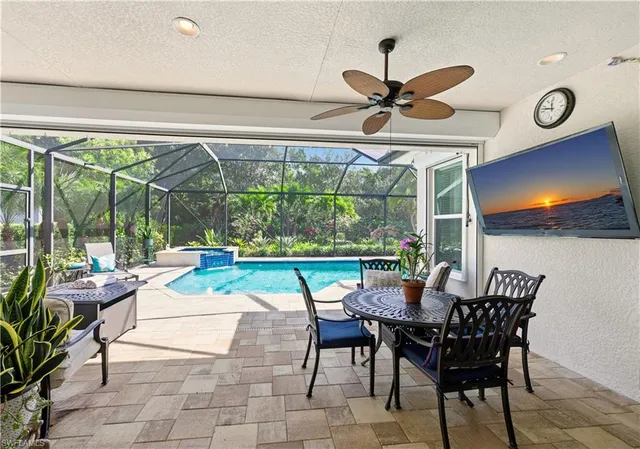 a view of a dining room with furniture and a large window