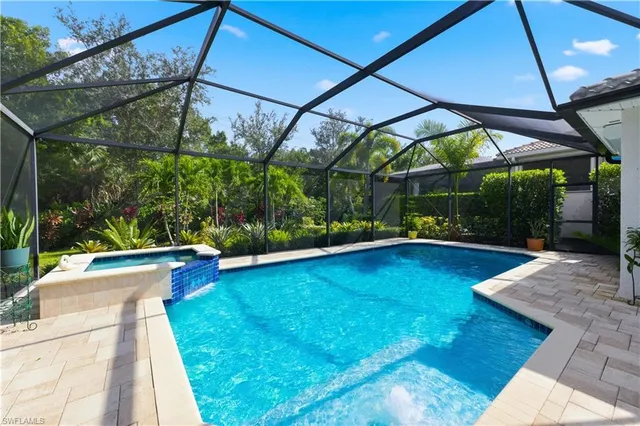 a dining room with wooden floor a chandelier a wooden table and chairs