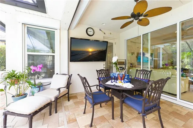 a bedroom with a large bed and a flat tv screen on dresser