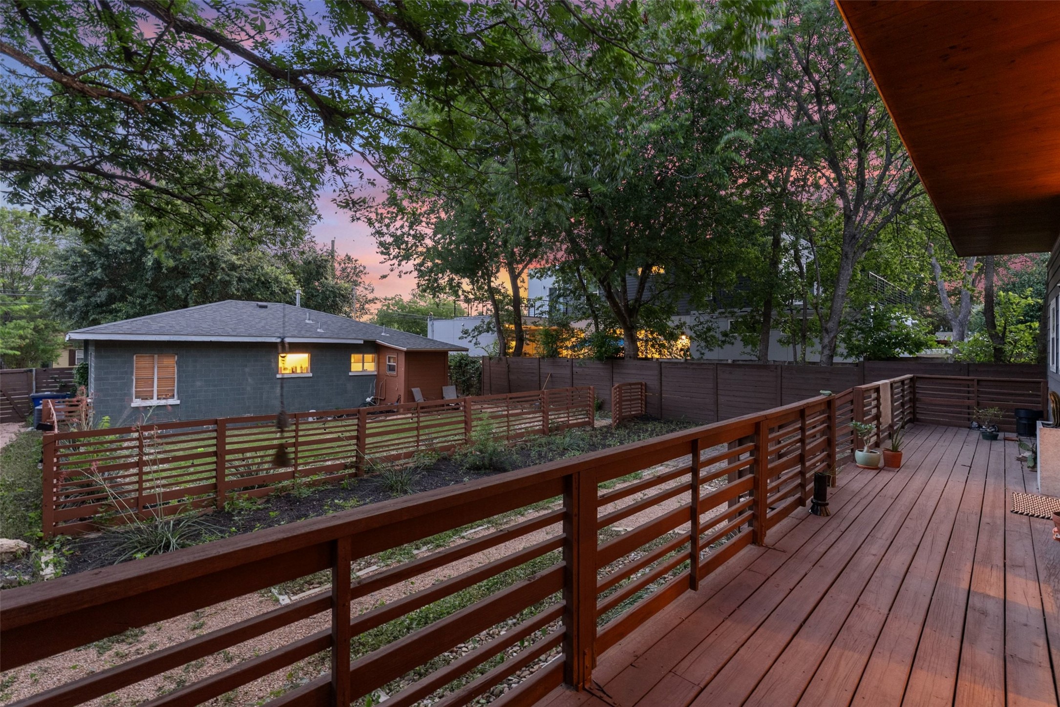 412 West Croslin Street Austin, TX 78752 - Photo 33 of 36 A spacious wooden deck extends to a fenced yard, perfect for outdoor enjoyment.