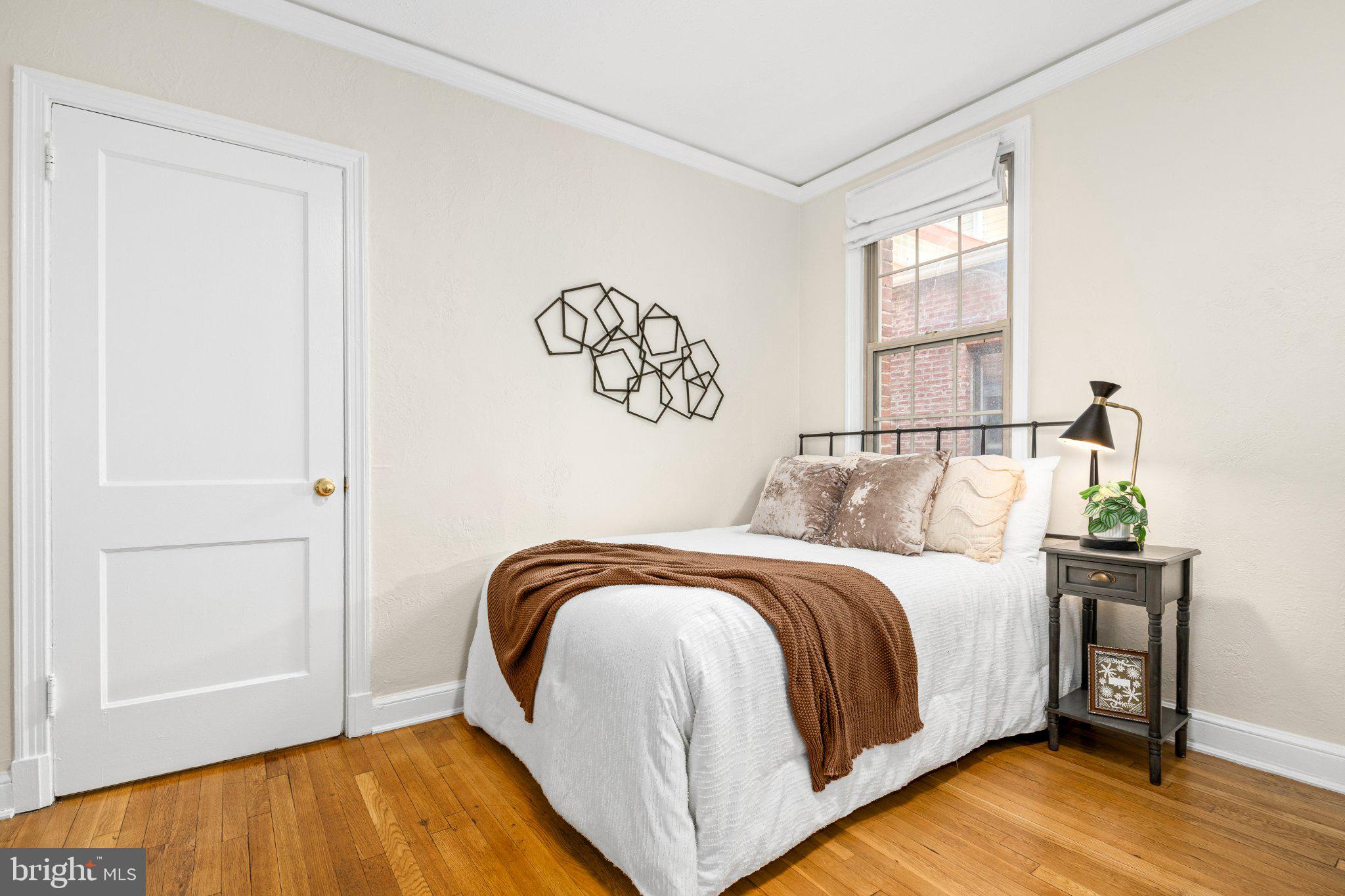 1439 Euclid Street Northwest, Unit 204 Washington, DC 20009 - Photo 6 of 12 Cozy bedroom with natural light.
