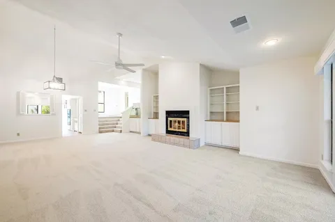 a view of a kitchen with a sink and a fireplace