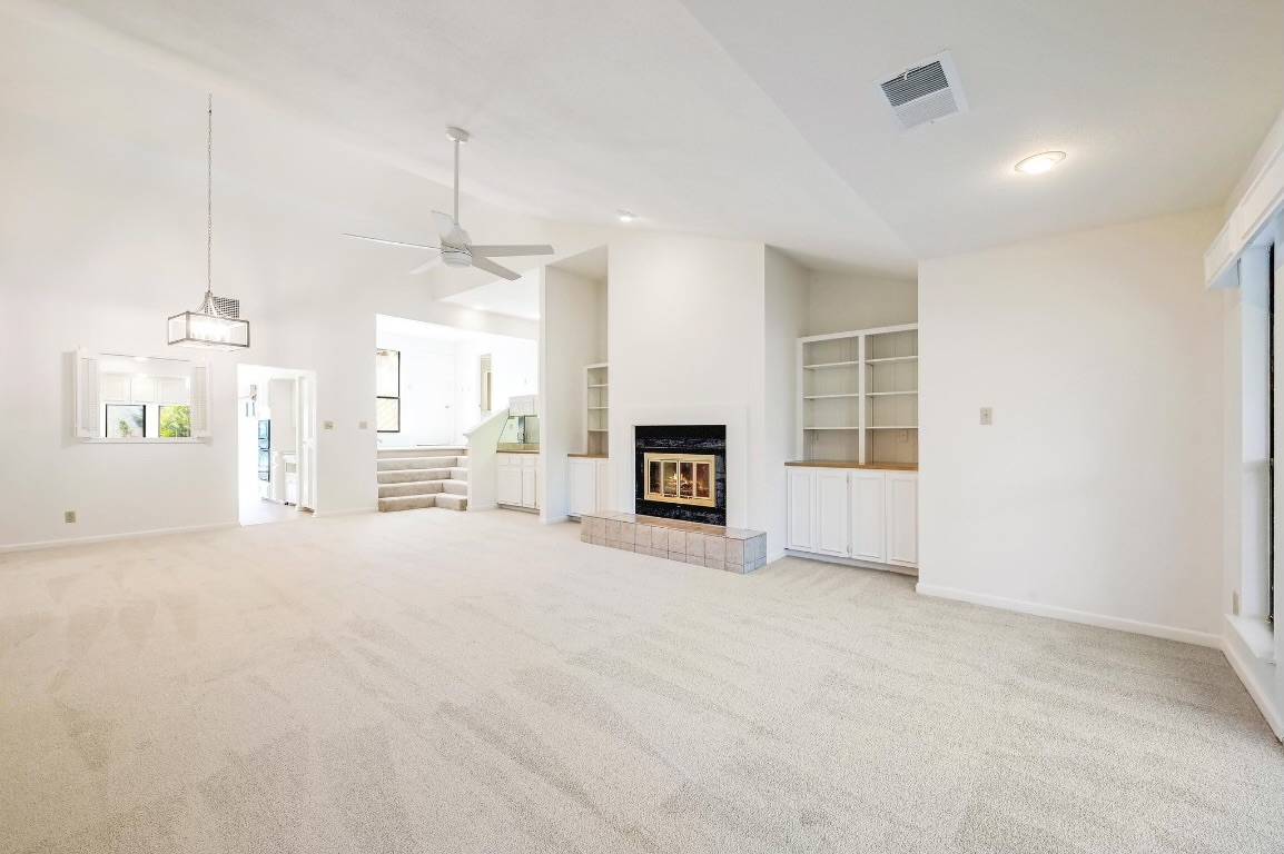 a view of a kitchen with a sink and a fireplace