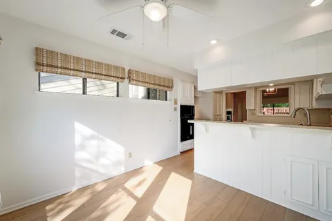 a view of kitchen with furniture and wooden floor