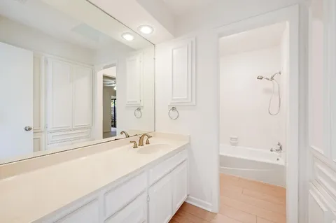 a bathroom with a shower sink and mirror