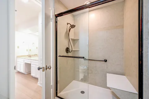 a bathroom with a shower and a sink