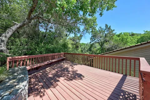 a view of balcony with wooden floor and fence