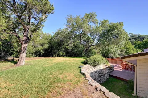 a view of a backyard both side of the house