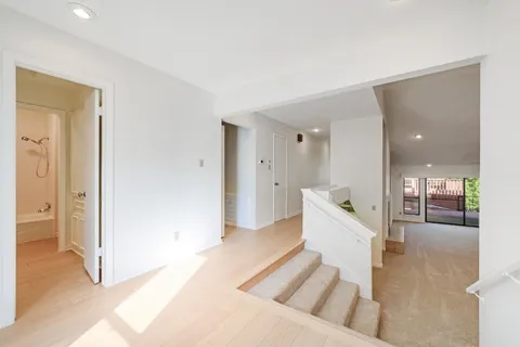 a large white room with a tub and shower