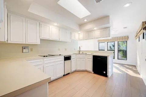 a kitchen with a stove top oven sink and cabinets