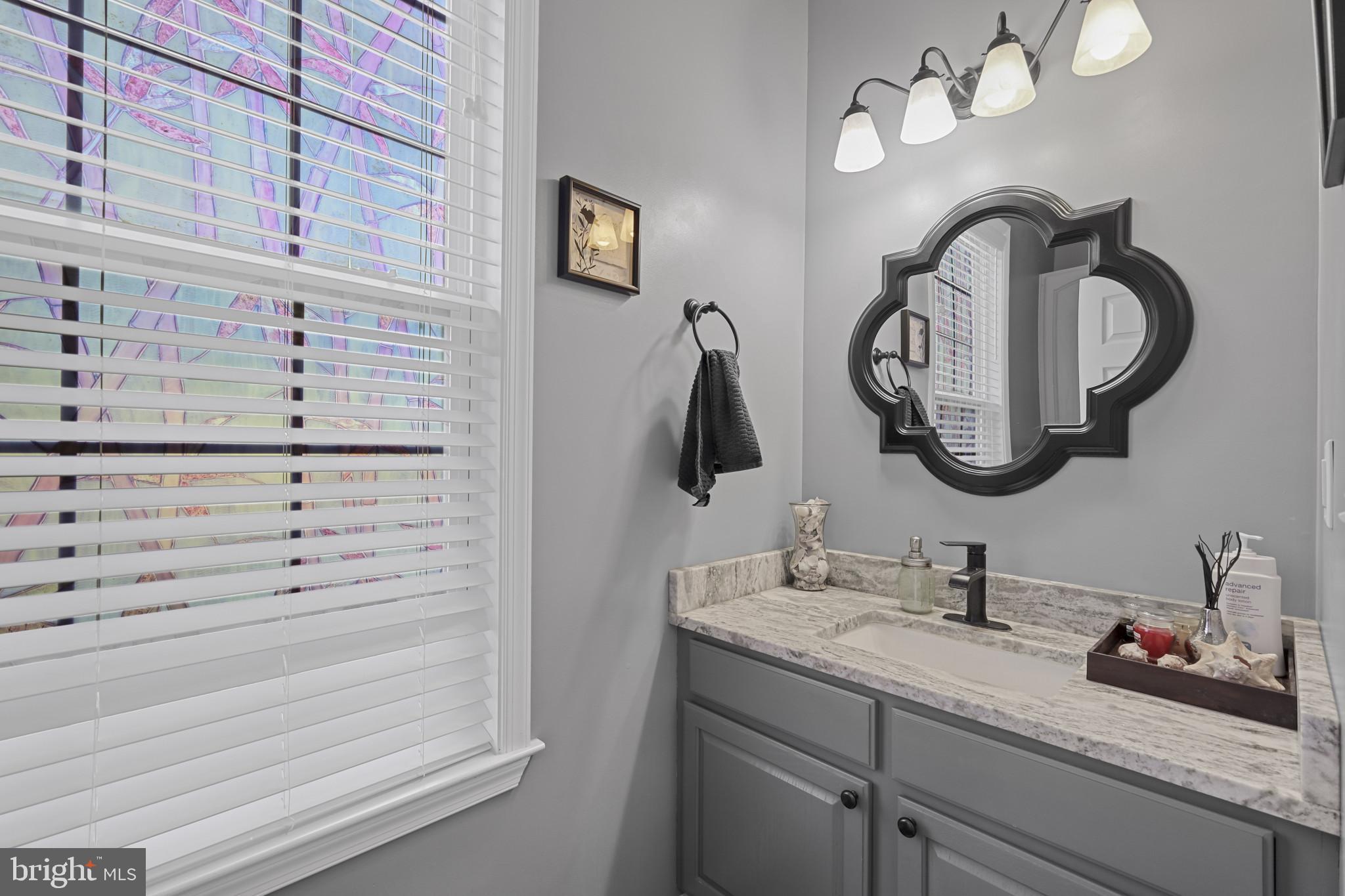 4220 Kings Road Edgewater, MD 21037 - Photo 11 of 78 a bathroom with a sink and a mirror