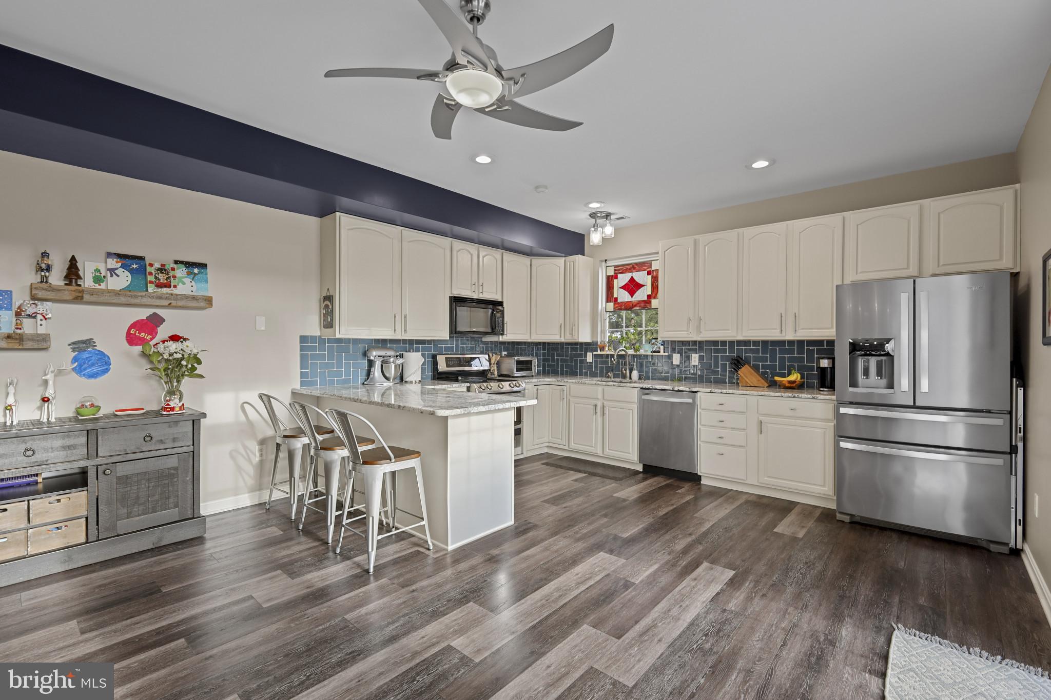 4220 Kings Road Edgewater, MD 21037 - Photo 21 of 78 a kitchen with white cabinets stainless steel appliances and white appliances
