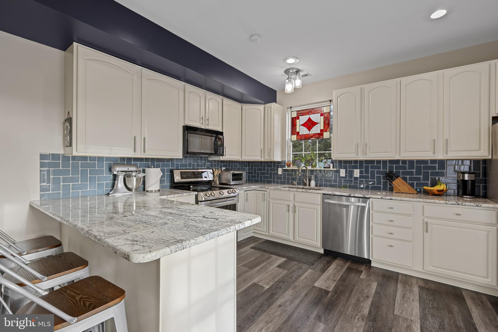 4220 Kings Road Edgewater, MD 21037 - Photo 24 of 78 a kitchen with granite countertop a sink stove and cabinets