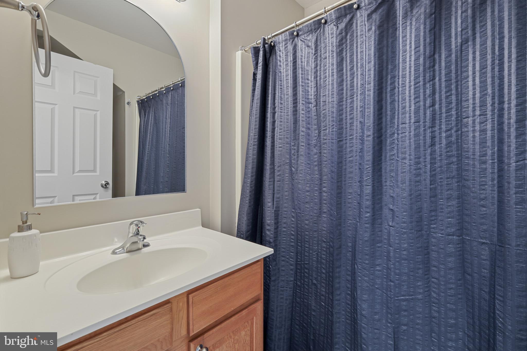 4220 Kings Road Edgewater, MD 21037 - Photo 33 of 78 a bathroom with a sink and a mirror