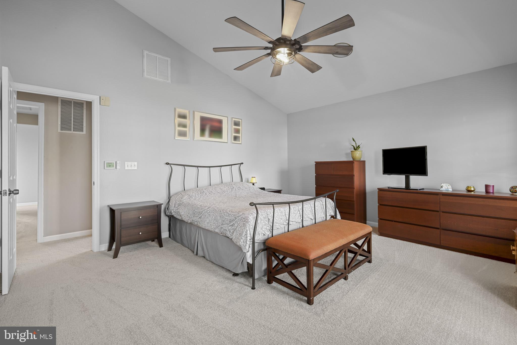 4220 Kings Road Edgewater, MD 21037 - Photo 35 of 78 a spacious bedroom with a bed and a chandelier