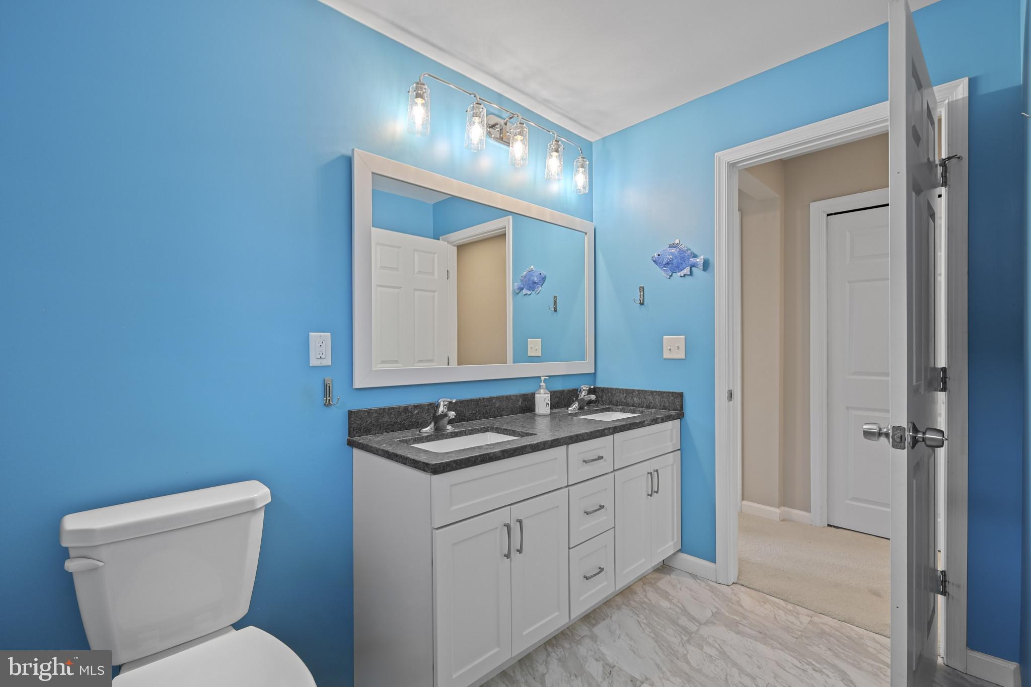 4220 Kings Road Edgewater, MD 21037 - Photo 44 of 78 a bathroom with a toilet sink and mirror