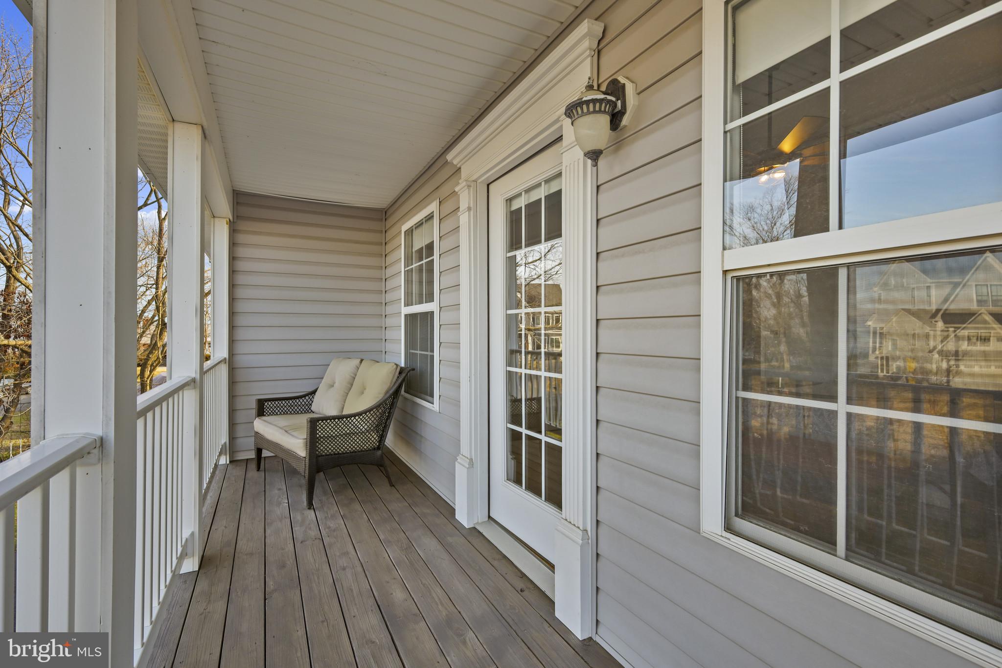 4220 Kings Road Edgewater, MD 21037 - Photo 7 of 78 a view of a balcony with chairs and wooden floor