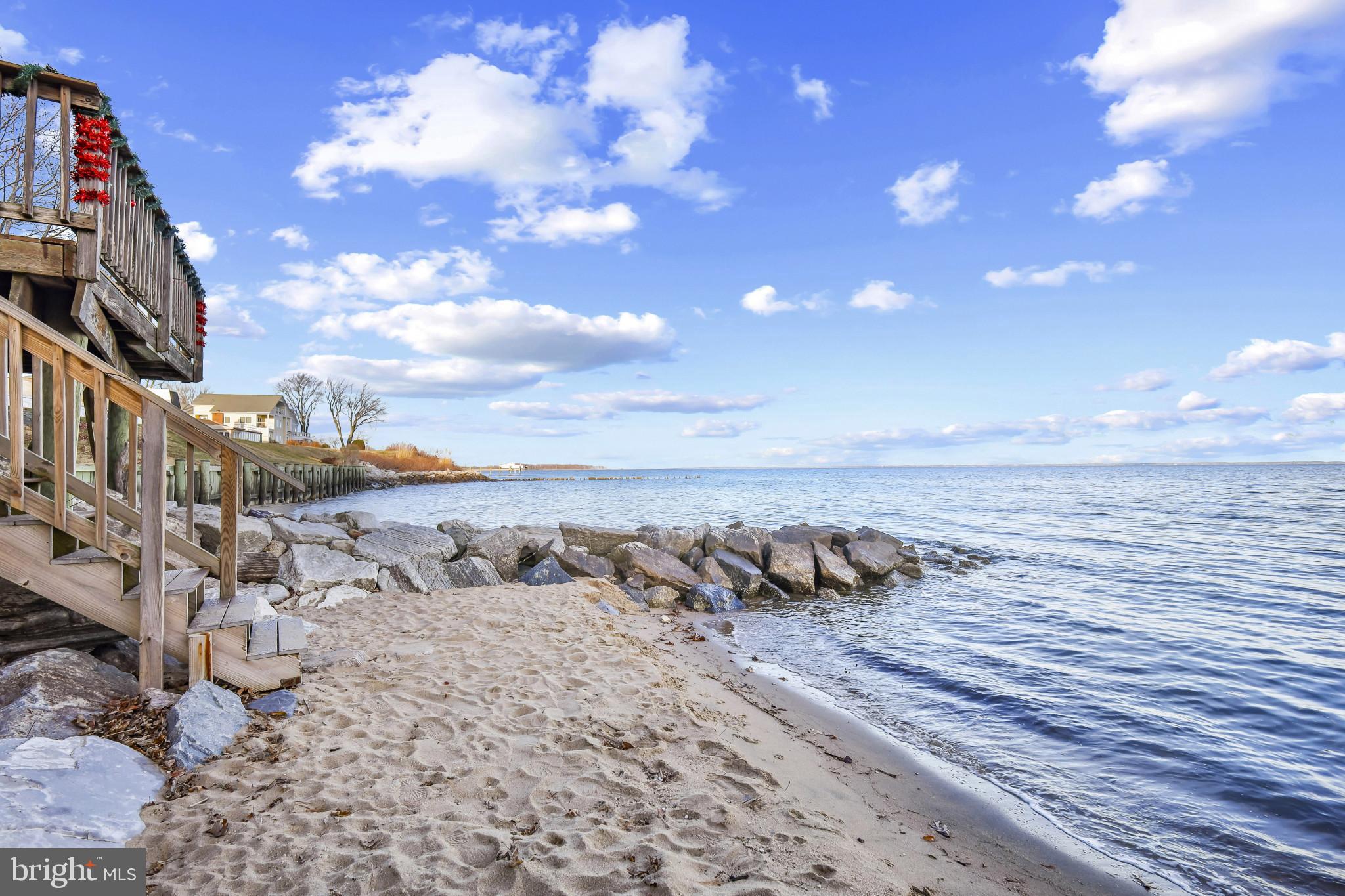 4220 Kings Road Edgewater, MD 21037 - Photo 73 of 78 Serene shoreline with gentle waves and clouds.