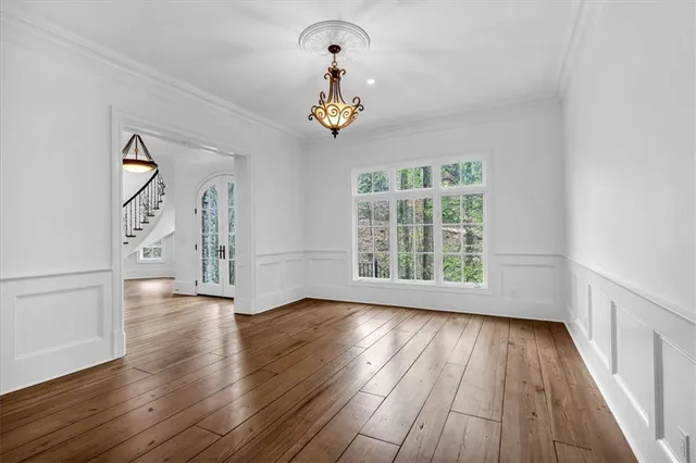 a large kitchen with stainless steel appliances a stove a sink a counter top space and cabinets