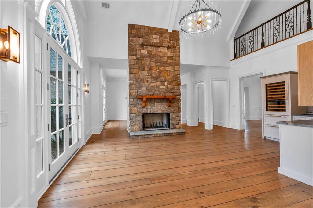 115 Mount Paran Ridge Atlanta, GA 30327 - Photo 15 of 85 a view of an empty room with wooden floor and a fireplace