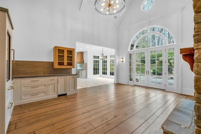 a large kitchen with stainless steel appliances kitchen island granite countertop a large counter top a stove and a shower