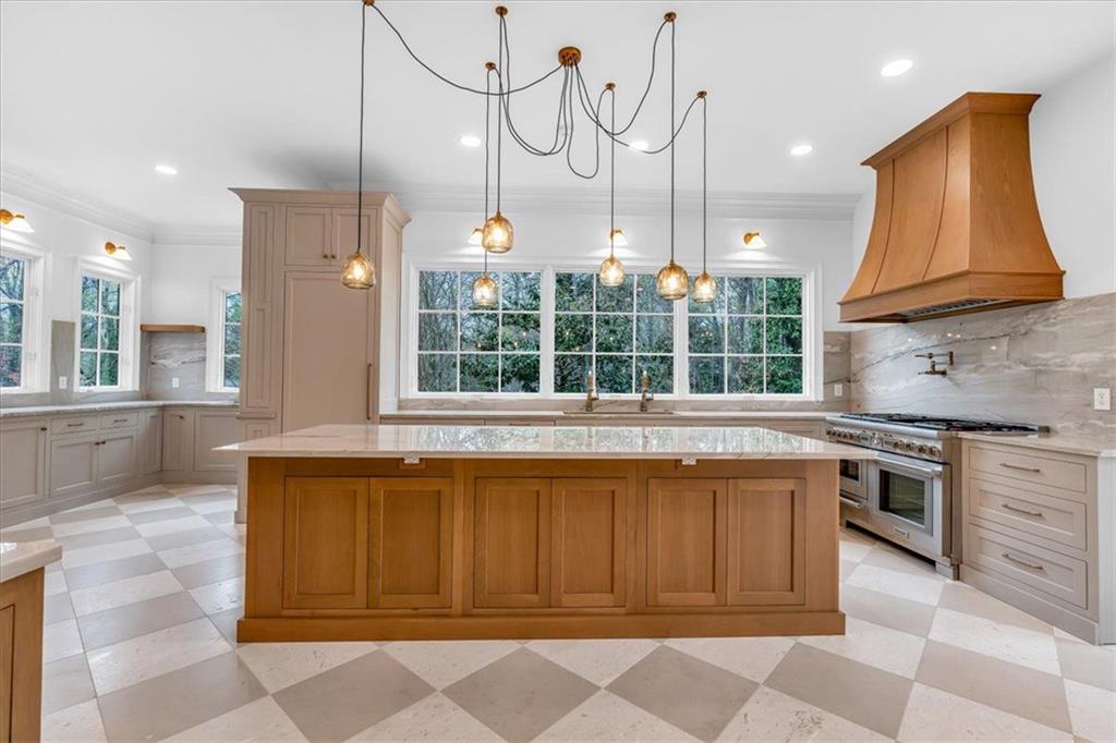 115 Mount Paran Ridge Atlanta, GA 30327 - Photo 25 of 85 a kitchen with stainless steel appliances granite countertop a stove a sink and a refrigerator