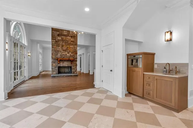 a view of a big room with wooden floor and a ceiling fan