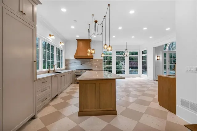 a bathroom with a granite countertop sink a mirror and a shower