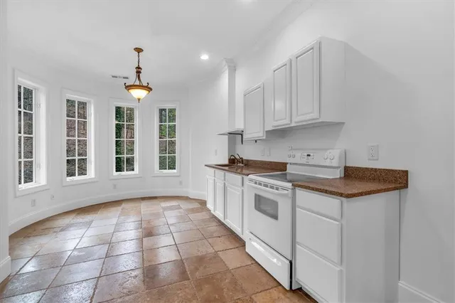 a spacious bathroom with a granite countertop sink and a tub