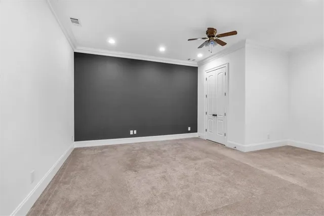 a white toilet sitting next to a white wall