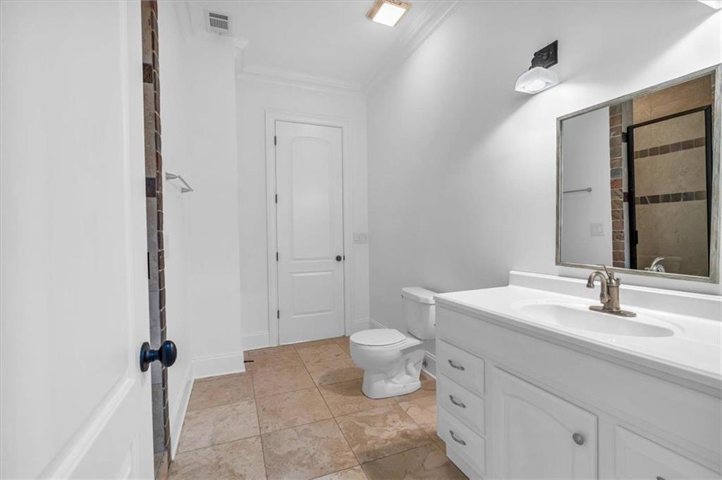 115 Mount Paran Ridge Atlanta, GA 30327 - Photo 43 of 85 a bathroom with a toilet sink and mirror