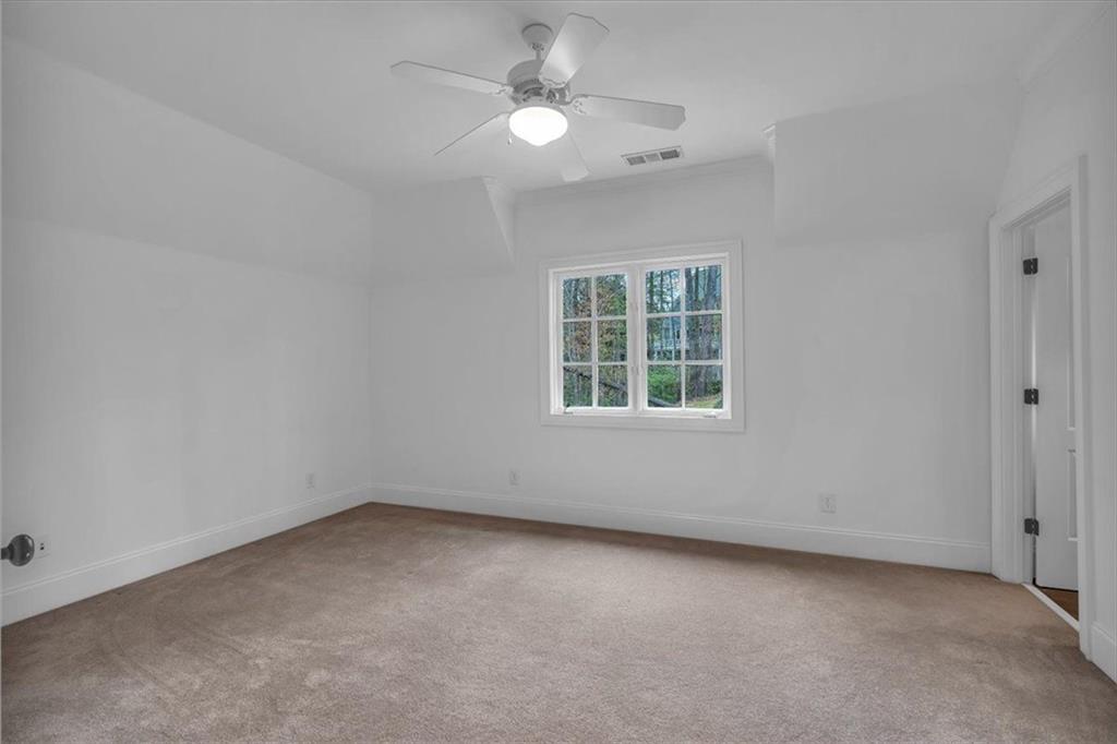 115 Mount Paran Ridge Atlanta, GA 30327 - Photo 46 of 85 an empty room with a window and a ceiling fan