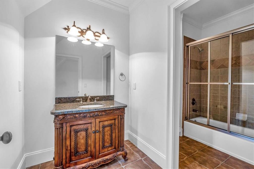 115 Mount Paran Ridge Atlanta, GA 30327 - Photo 47 of 85 a bathroom with a granite countertop sink a mirror and a shower
