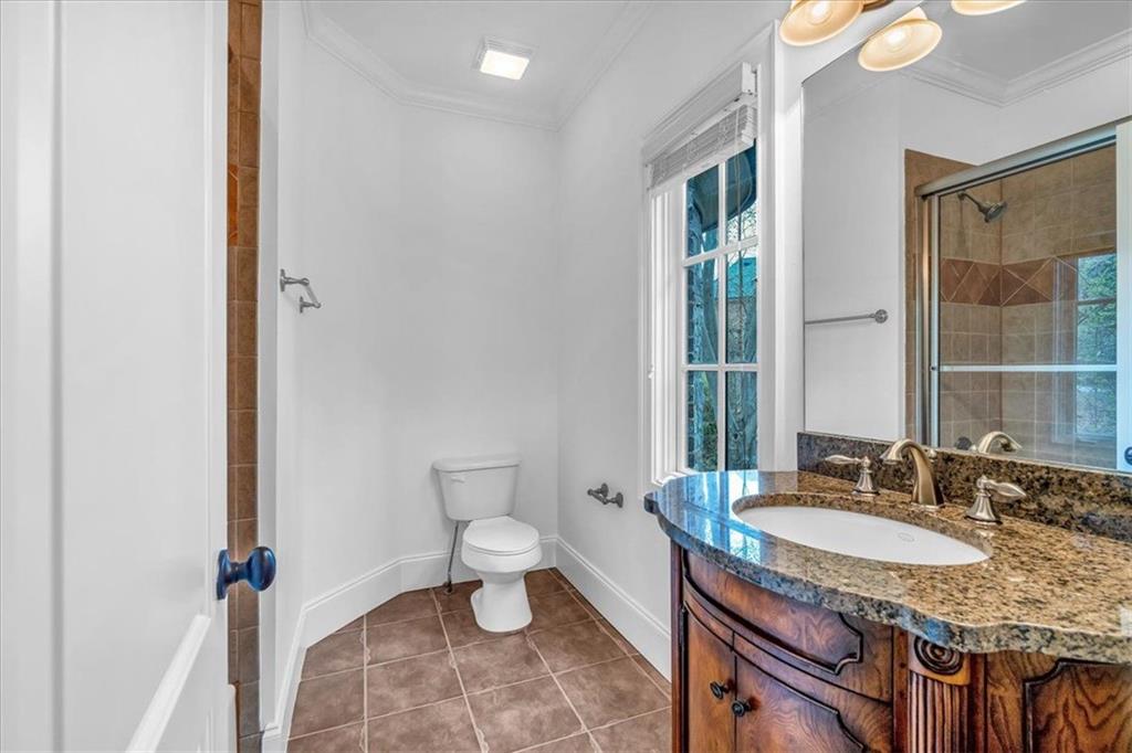 115 Mount Paran Ridge Atlanta, GA 30327 - Photo 52 of 85 a bathroom with a granite countertop sink and a mirror